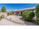 Attractive backyard with desert landscaping, covered patio, privacy wall, and mature foliage at 11529 E Lindner Ave, Mesa, AZ 85209