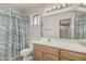 Well-maintained bathroom featuring a vanity, mirror, and shower with decorative shower curtain at 11529 E Lindner Ave, Mesa, AZ 85209