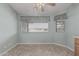 Bright bedroom featuring neutral walls, tile flooring, and a large window for natural light at 11529 E Lindner Ave, Mesa, AZ 85209