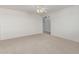 Spacious bedroom with neutral carpet and an archway leading to other areas of the house at 11529 E Lindner Ave, Mesa, AZ 85209