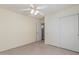 Cozy bedroom with a ceiling fan, closet, and doorway, providing a comfortable retreat at 11529 E Lindner Ave, Mesa, AZ 85209