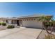 Well-maintained home with a two-car garage, complemented by desert landscaping and a quaint front porch at 11529 E Lindner Ave, Mesa, AZ 85209