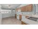 Bright kitchen with wood cabinets, white appliances, and a view to the outside at 11529 E Lindner Ave, Mesa, AZ 85209