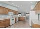Spacious kitchen featuring white appliances and wood cabinets offering ample storage space at 11529 E Lindner Ave, Mesa, AZ 85209