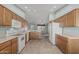 Spacious kitchen featuring white appliances and wood cabinets offering ample storage space at 11529 E Lindner Ave, Mesa, AZ 85209
