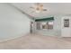 Spacious living room with neutral carpet, ceiling fan, and windows providing natural light, perfect for relaxing at 11529 E Lindner Ave, Mesa, AZ 85209