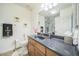 Clean bathroom featuring single sink vanity, toilet, and shower with a glass door at 14575 W Mountain View Blvd # 11212, Surprise, AZ 85374
