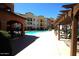 Beautiful community pool and pergola in a multi-Gathering home complex with seating areas at 14575 W Mountain View Blvd # 11212, Surprise, AZ 85374
