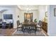 Traditional dining room with beautiful wood floors, overhead lighting and a built-in china cabinet at 14575 W Mountain View Blvd # 11212, Surprise, AZ 85374
