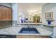 Lovely kitchen view featuring granite countertops, a sink, and the open concept living and dining spaces at 14575 W Mountain View Blvd # 11212, Surprise, AZ 85374