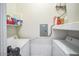 Functional laundry room with a side-by-side washer and dryer, and shelf storage at 14575 W Mountain View Blvd # 11212, Surprise, AZ 85374