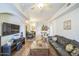 Bright and airy living room with modern furnishings, hardwood floors, and an open layout to the kitchen at 14575 W Mountain View Blvd # 11212, Surprise, AZ 85374