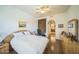 Well-lit main bedroom with a large bed, wooden furniture, and a view of the hallway at 14575 W Mountain View Blvd # 11212, Surprise, AZ 85374