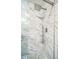 Elegant shower with marble tiling, rainfall shower head, and hand shower at 14575 W Mountain View Blvd # 11212, Surprise, AZ 85374
