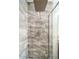 Modern shower with marble-style tiling, rainfall shower head, and hand shower at 14575 W Mountain View Blvd # 11212, Surprise, AZ 85374