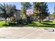 Outdoor basketball court area with green grass and residential building in the background at 14870 W Encanto Blvd # 1106, Goodyear, AZ 85395