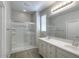 Bathroom with double sink vanity, a shower with a glass enclosure and tile floors at 14870 W Encanto Blvd # 1106, Goodyear, AZ 85395
