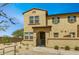Charming two-story home featuring a stucco facade, arched entryway, and desert landscaping at 14870 W Encanto Blvd # 1106, Goodyear, AZ 85395