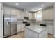 Well-appointed kitchen with stainless steel appliances, granite countertops and a center island at 14870 W Encanto Blvd # 1106, Goodyear, AZ 85395