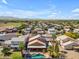 Stunning aerial view of neighborhood featuring a beautiful pool and well-maintained landscaping at 16040 W Grant St, Goodyear, AZ 85338