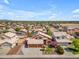 Nice aerial view of a home with desert landscaping, a tiled roof, and a three-car garage at 16040 W Grant St, Goodyear, AZ 85338