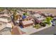 An aerial view of home with installed solar panels, a backyard with a pool, and lush desert landscaping at 16040 W Grant St, Goodyear, AZ 85338