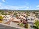 Beautiful aerial view of a Gathering home with mature desert landscaping, a three-car garage, and a tiled roof at 16040 W Grant St, Goodyear, AZ 85338