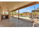 Spacious covered back patio overlooking a private pool, bar area, and lush backyard, perfect for outdoor living at 16040 W Grant St, Goodyear, AZ 85338