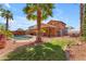 Enjoy the backyard with a covered patio, refreshing pool, lush landscaping, and mature palm trees at 16040 W Grant St, Goodyear, AZ 85338