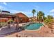Serene backyard oasis with a gazebo, patio, BBQ, a pool, and beautiful rock landscaping at 16040 W Grant St, Goodyear, AZ 85338
