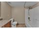 Bathroom featuring a toilet, tiled floors, and a shower/tub combo, offering functional design at 16040 W Grant St, Goodyear, AZ 85338