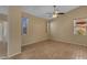 Inviting bedroom with wood-look flooring and multiple windows that brighten the interior space at 16040 W Grant St, Goodyear, AZ 85338
