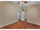 Neutral bedroom featuring a ceiling fan, closet, and wood-look floors, offering a cozy space at 16040 W Grant St, Goodyear, AZ 85338