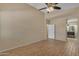 Spacious bedroom boasts wood-look flooring, ceiling fan, and convenient access to the en-suite bathroom at 16040 W Grant St, Goodyear, AZ 85338