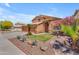 Charming two-story home with beautifully landscaped front yard, desert plants, and a three-car garage at 16040 W Grant St, Goodyear, AZ 85338