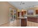 Well-equipped kitchen with granite counters, wood cabinets, an island and stainless steel appliances at 16040 W Grant St, Goodyear, AZ 85338