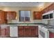 Well-appointed kitchen featuring granite countertops, sleek white appliances, and ample cabinet space for storage at 16040 W Grant St, Goodyear, AZ 85338