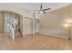 Spacious living room with tile flooring, high ceilings, and a ceiling fan for a cool and inviting atmosphere at 16040 W Grant St, Goodyear, AZ 85338