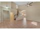 Spacious living room with high ceilings, staircase, tile flooring, and natural light, creating a welcoming atmosphere at 16040 W Grant St, Goodyear, AZ 85338