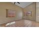 Bright living room featuring tile floors, large windows, and vaulted ceilings, creating an airy and inviting space at 16040 W Grant St, Goodyear, AZ 85338
