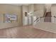 Spacious living room featuring tile floors, high ceilings, natural light, and a staircase at 16040 W Grant St, Goodyear, AZ 85338