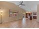 Inviting living room with tile flooring, large windows, and an open connection to the kitchen, perfect for modern living at 16040 W Grant St, Goodyear, AZ 85338