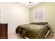 Bedroom with a queen bed, window with shutters, and side table at 16817 W Bradford Way, Surprise, AZ 85374