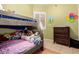 bedroom with bunk beds, decorative dresser, fun decorations and tile flooring at 16817 W Bradford Way, Surprise, AZ 85374