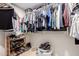 Walk-in closet with clothing, shelving, shoe racks, and ample storage space at 16817 W Bradford Way, Surprise, AZ 85374