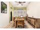Dining room boasts a wooden table, chairs, cabinet, and light green walls with large window at 16817 W Bradford Way, Surprise, AZ 85374