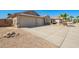Well maintained driveway to attached 2 car garage, desert landscaping and tile roof in this property at 16817 W Bradford Way, Surprise, AZ 85374
