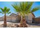 Charming single-story home with desert landscaping, palm trees, and spacious three-car garage at 16817 W Bradford Way, Surprise, AZ 85374