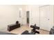 Home gym featuring weightlifting equipment and window with shutters at 16817 W Bradford Way, Surprise, AZ 85374