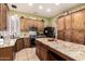 Spacious kitchen features wood cabinets, stainless steel appliances, and a granite-topped island at 16817 W Bradford Way, Surprise, AZ 85374